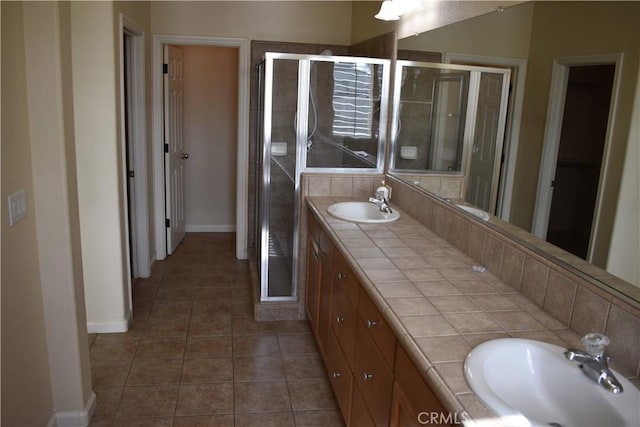 bathroom with vanity, a shower with shower door, and tile patterned floors