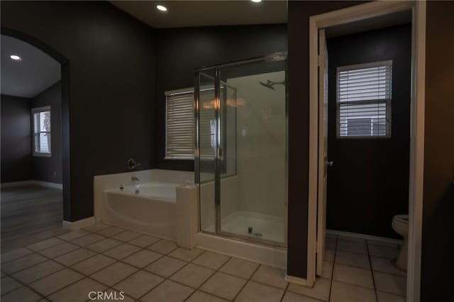 bathroom with tile patterned floors, toilet, and plus walk in shower