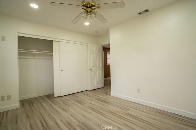 unfurnished bedroom with ceiling fan, a closet, and light hardwood / wood-style flooring