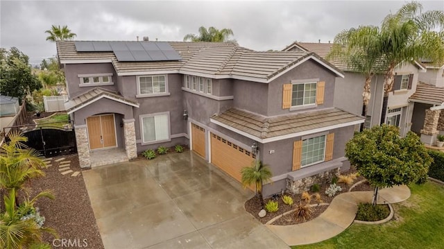 view of front of house featuring a garage and solar panels