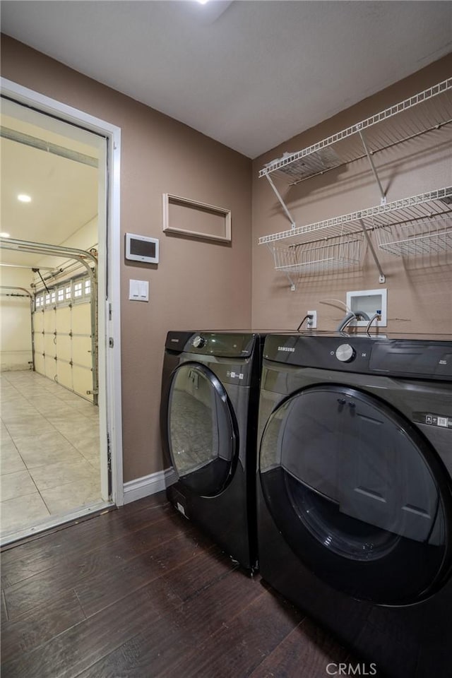 laundry room featuring hardwood / wood-style flooring and washer and dryer