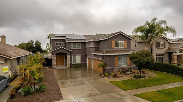 view of front of house featuring a garage and solar panels