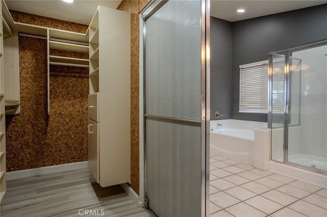 bathroom featuring tile patterned floors and separate shower and tub