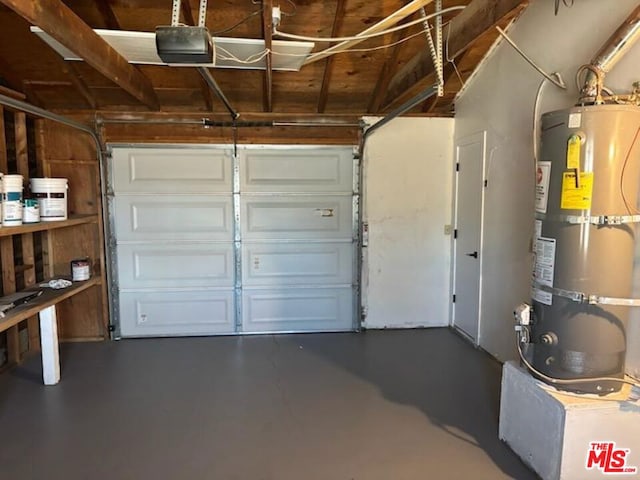 garage featuring a garage door opener and strapped water heater