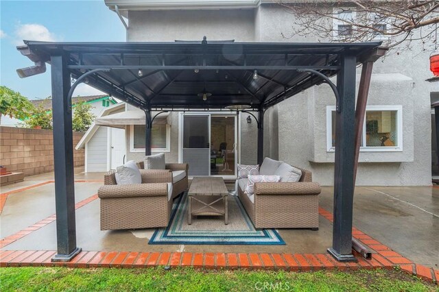 view of patio / terrace with outdoor lounge area, a gazebo, and fence