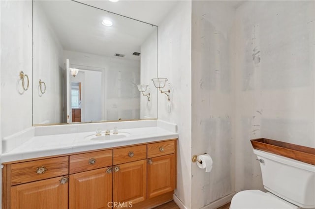 bathroom featuring vanity and toilet