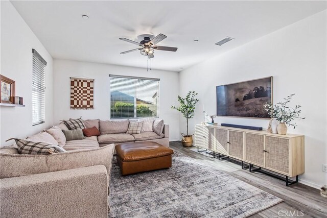 30219 Old Mill Rd, Menifee, CA 92584 - living room featuring wood finished floors, ceiling fan, and baseboards