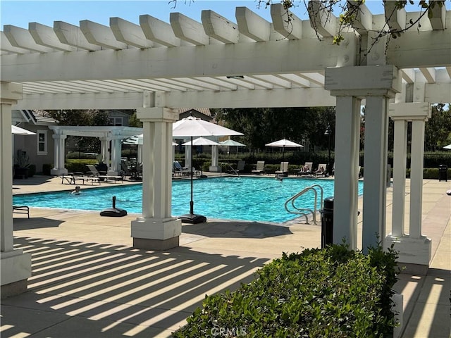 view of swimming pool with a patio and a pergola