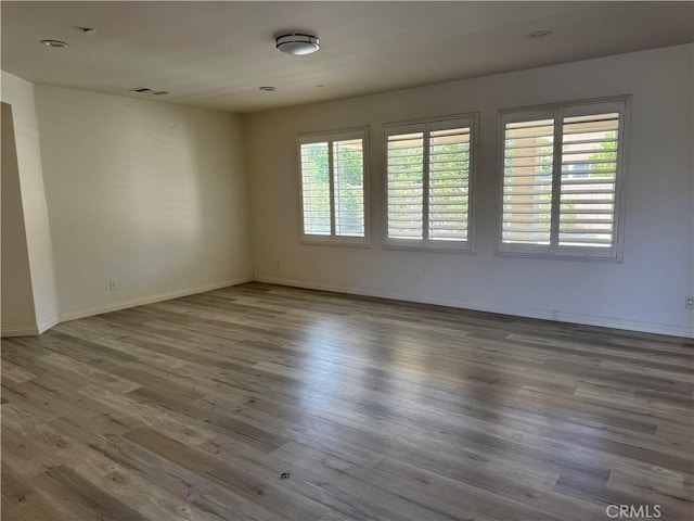 spare room featuring hardwood / wood-style floors