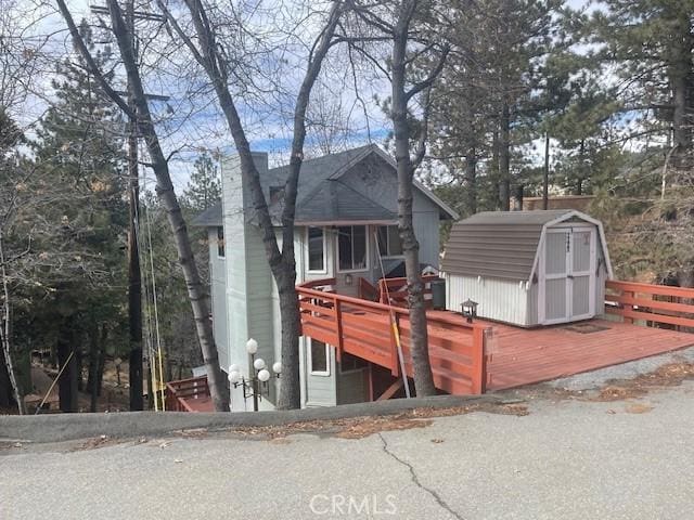 exterior space with a deck and a shed