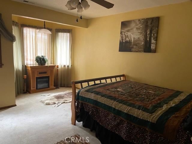 carpeted bedroom featuring ceiling fan