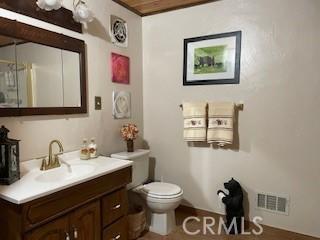 bathroom featuring vanity and toilet