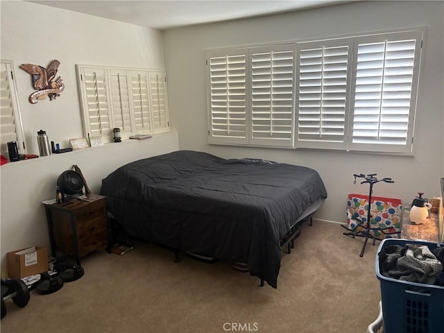 bedroom featuring light carpet