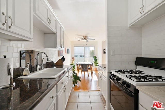 kitchen with white cabinetry, sink, ceiling fan, and range with gas cooktop