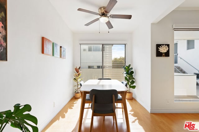 dining area with ceiling fan and light hardwood / wood-style floors