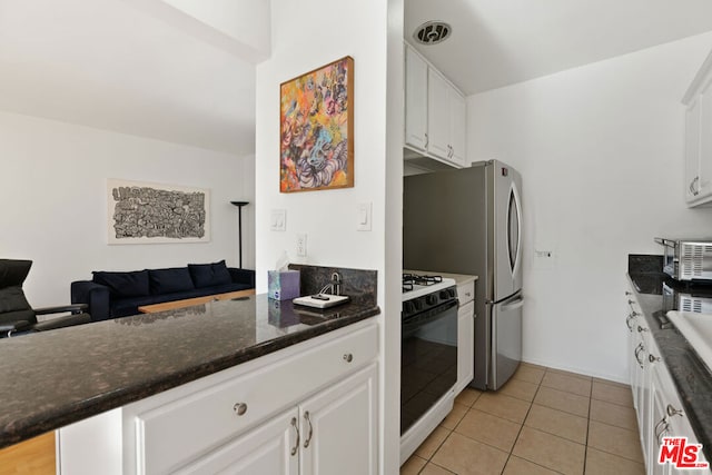 kitchen featuring gas stove, white cabinetry, light tile patterned floors, kitchen peninsula, and wall oven