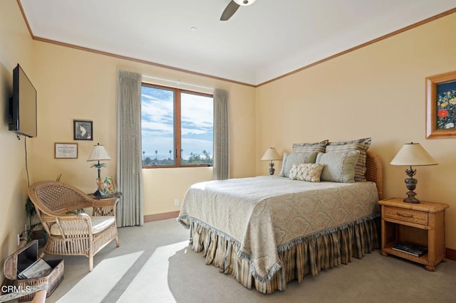 carpeted bedroom with ornamental molding, a ceiling fan, and baseboards