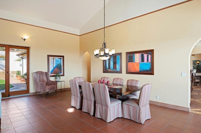 dining room with baseboards, arched walkways, dark tile patterned floors, high vaulted ceiling, and a notable chandelier