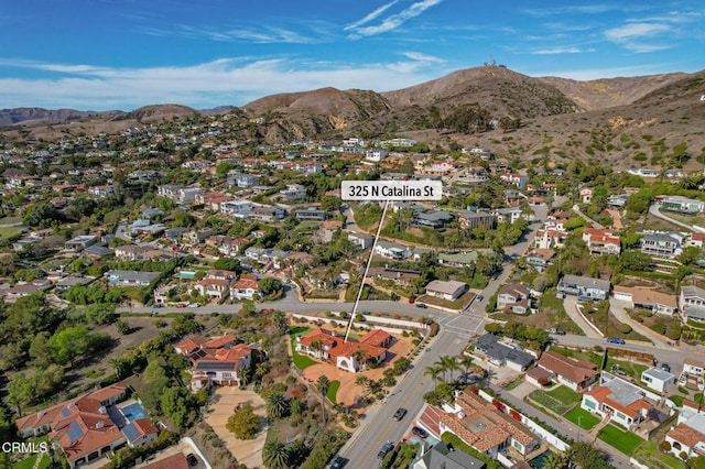 drone / aerial view featuring a residential view and a mountain view