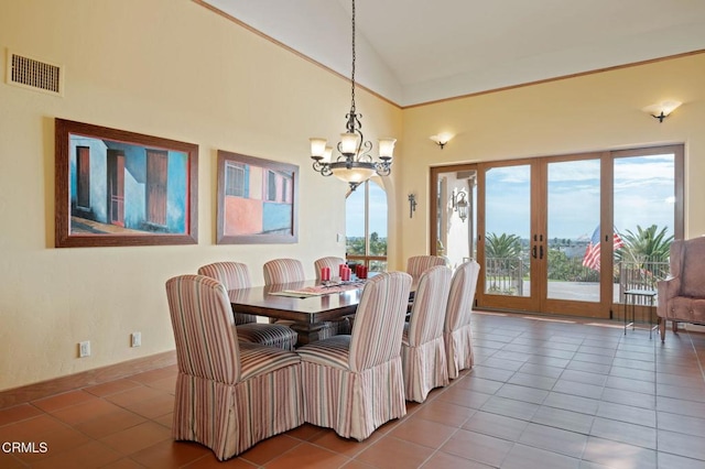 tiled dining area featuring high vaulted ceiling, french doors, visible vents, and a notable chandelier