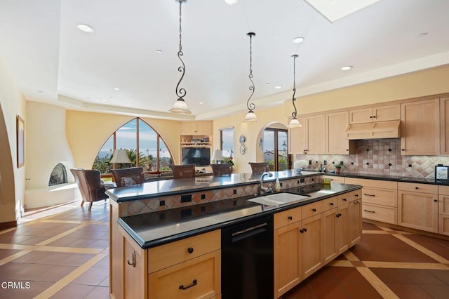 kitchen featuring a sink, decorative backsplash, dishwasher, light brown cabinetry, and dark countertops