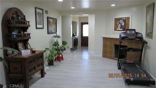 hall featuring washer and dryer and light wood-type flooring