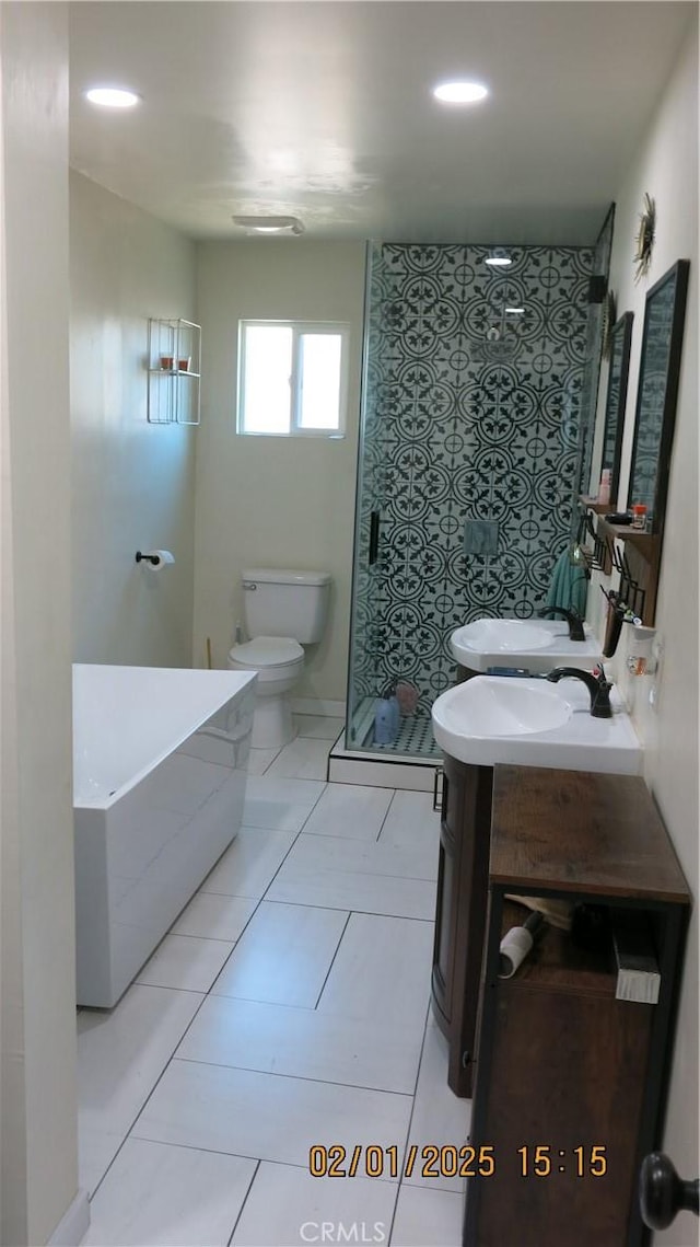 bathroom with walk in shower, vanity, and toilet