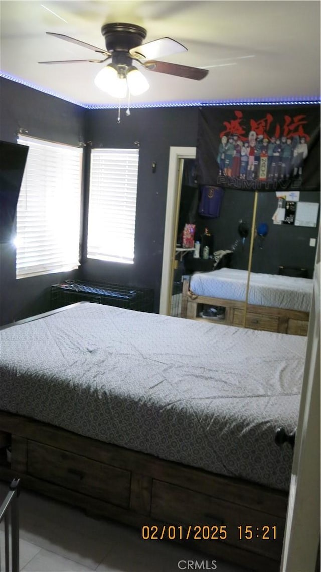 bedroom featuring ceiling fan and tile patterned floors