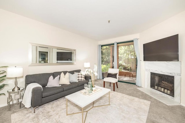 carpeted living room featuring a high end fireplace