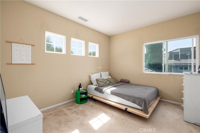 bedroom with light colored carpet