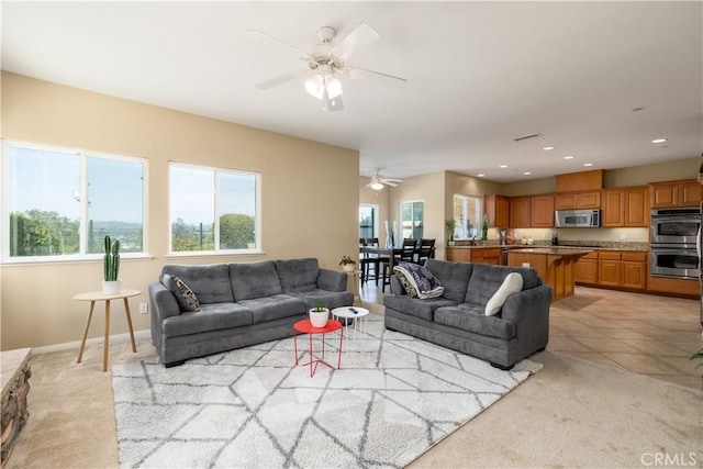 living room featuring light colored carpet and ceiling fan