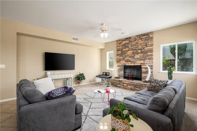 living room with ceiling fan, tile patterned floors, and a fireplace