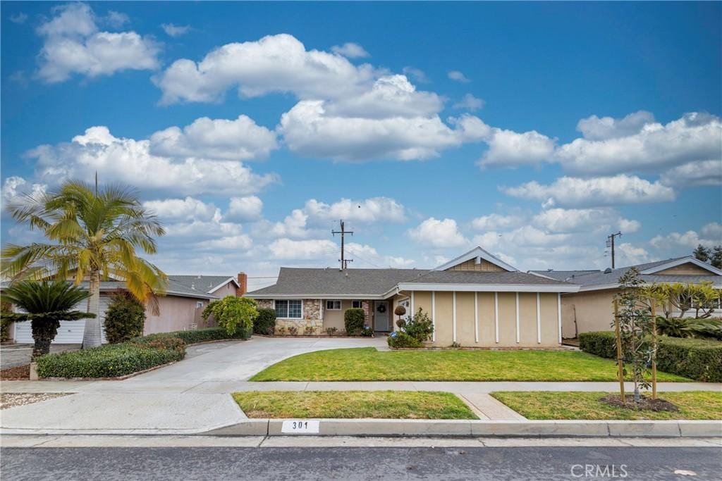 ranch-style house with a front lawn