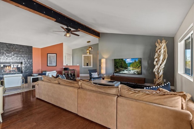 living room featuring dark hardwood / wood-style flooring and vaulted ceiling with beams