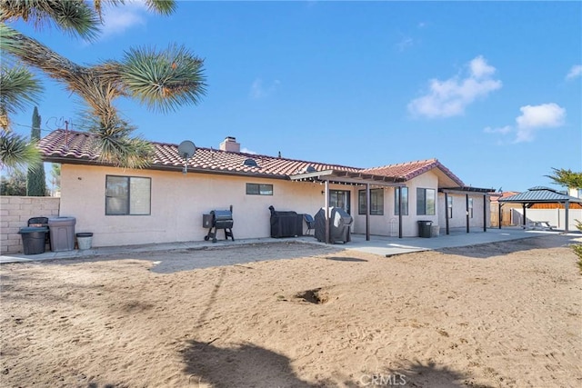 back of house featuring a gazebo and a patio