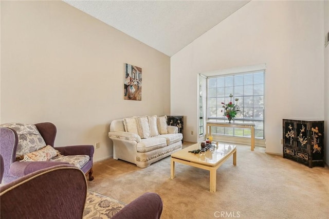 living room with high vaulted ceiling and light colored carpet