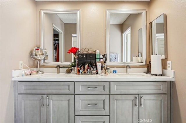 full bathroom featuring double vanity and a sink