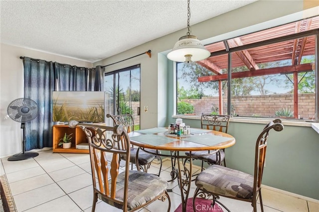 dining room featuring a textured ceiling and light tile patterned flooring