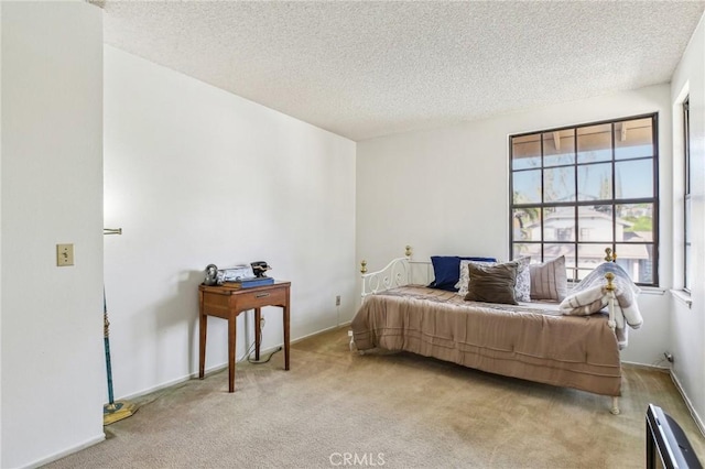 carpeted bedroom featuring a textured ceiling