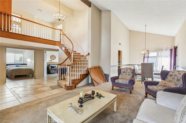 living room featuring stairs, carpet floors, plenty of natural light, and a notable chandelier