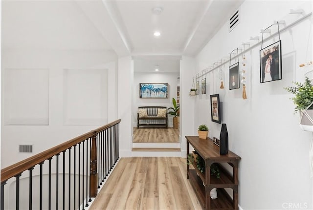 corridor with light hardwood / wood-style floors