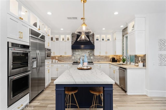 kitchen featuring appliances with stainless steel finishes, white cabinets, and a kitchen island