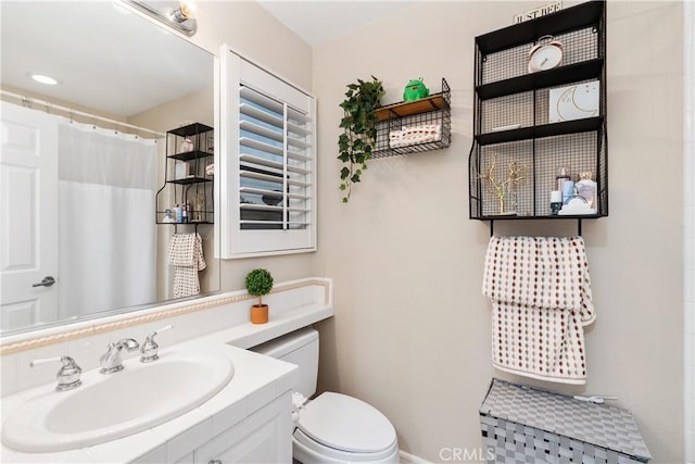 bathroom with vanity, walk in shower, and toilet