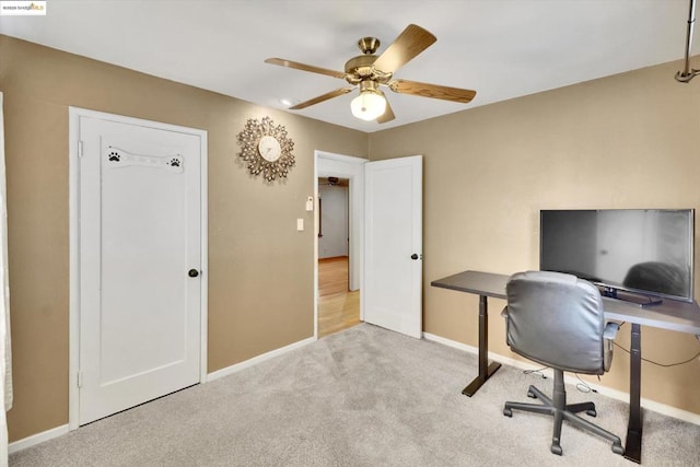 office space with light colored carpet and ceiling fan