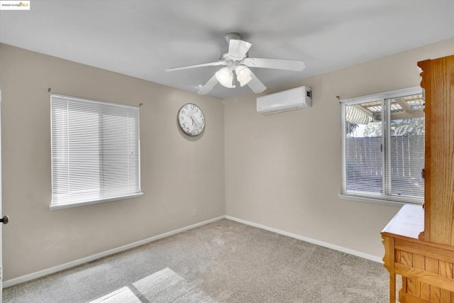 carpeted spare room with a wall mounted air conditioner and ceiling fan