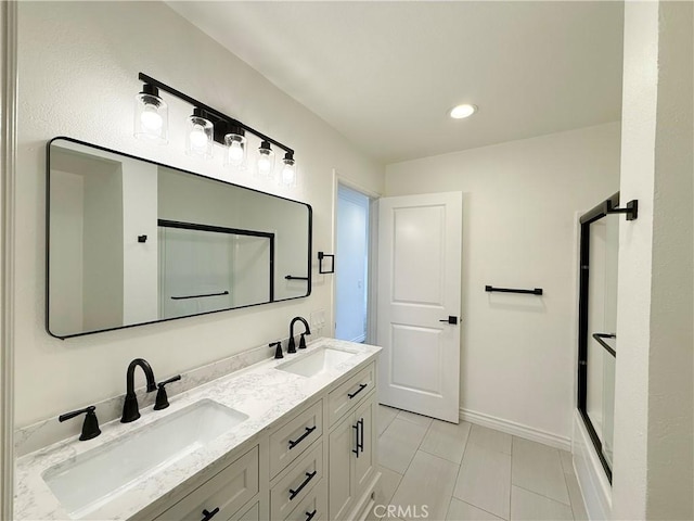 bathroom featuring tile patterned floors, vanity, and a shower with shower door