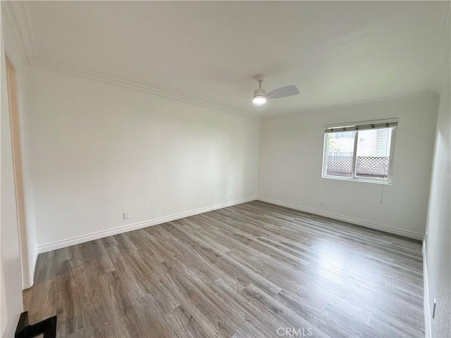 empty room featuring ceiling fan, ornamental molding, and light hardwood / wood-style floors