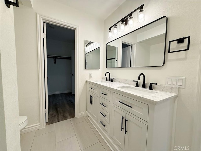 bathroom with tile patterned floors, toilet, and vanity