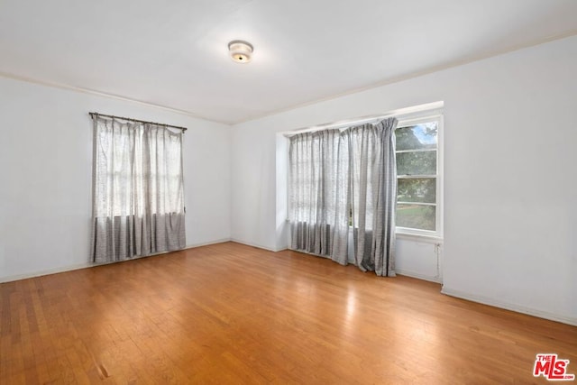 unfurnished room featuring hardwood / wood-style floors