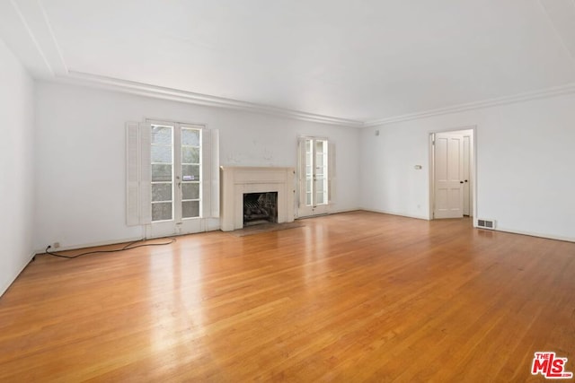 unfurnished living room with french doors and light wood-type flooring